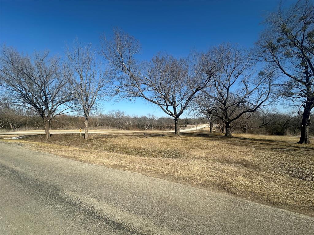 D South Inwood Street Sherman, TX 75090 - Photo 2 of 3 a view of dirt yard with a large tree