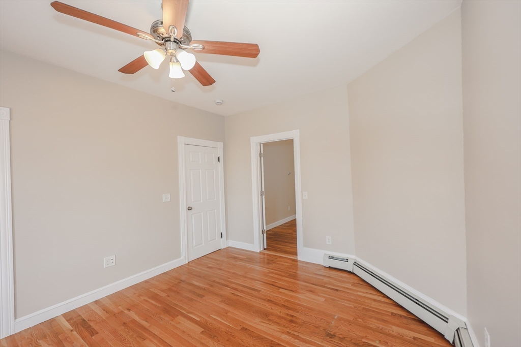 64 Bremen Street, Unit 3 Boston, MA 02128 - Photo 11 of 16 a view of an empty room with wooden floor