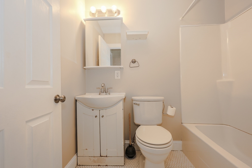 64 Bremen Street, Unit 3 Boston, MA 02128 - Photo 12 of 16 a bathroom with a sink toilet and a mirror