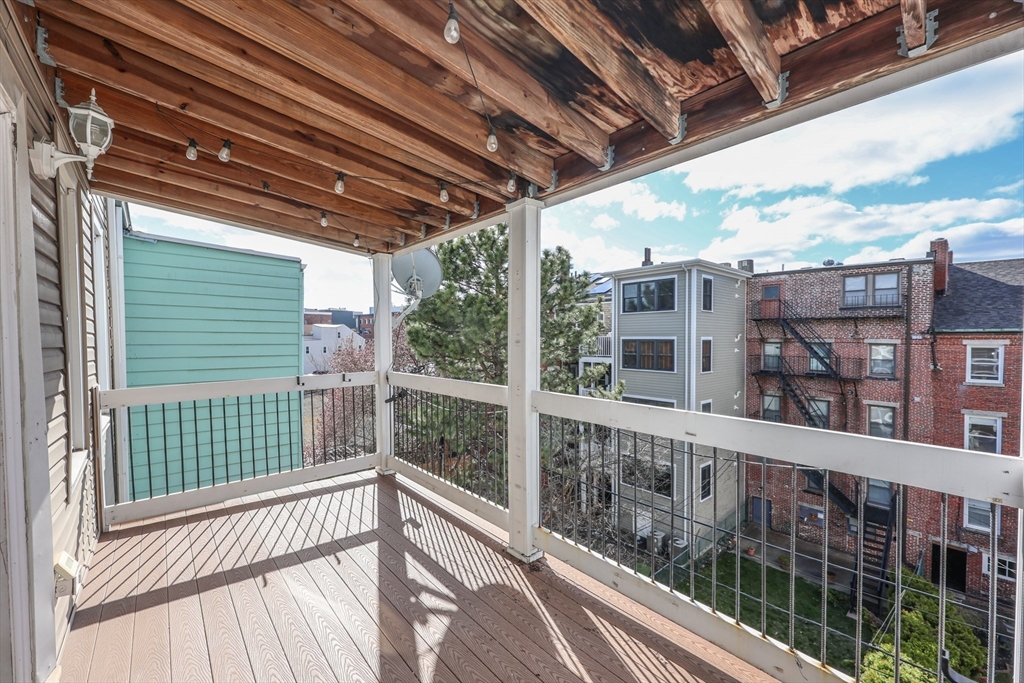 64 Bremen Street, Unit 3 Boston, MA 02128 - Photo 13 of 16 a view of a building from a balcony