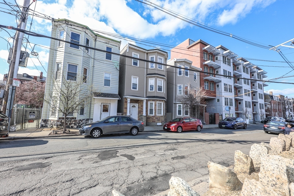 64 Bremen Street, Unit 3 Boston, MA 02128 - Photo 16 of 16 a cars parked in front of brick building