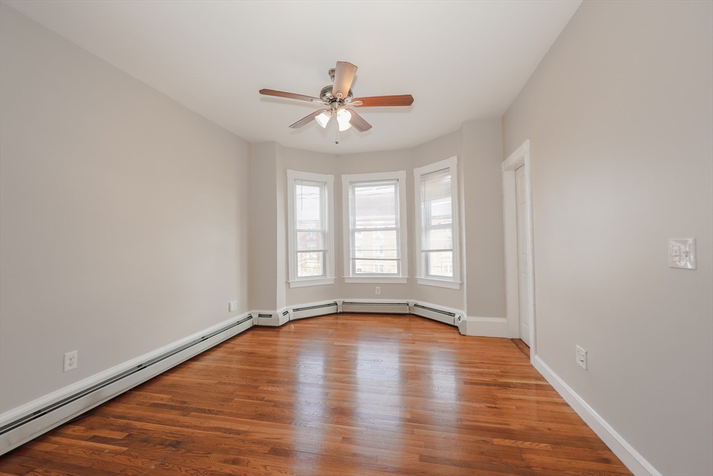 64 Bremen Street, Unit 3 Boston, MA 02128 - Photo 9 of 16 wooden floor in an empty room with a window