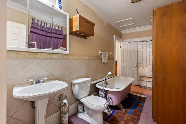 a bathroom with a tub sink and mirror