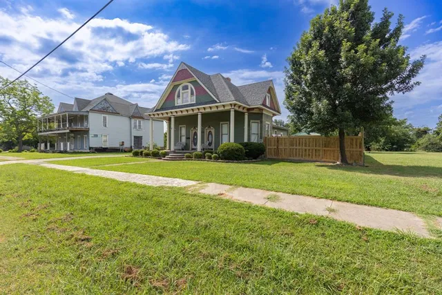 a front view of house with yard and green space