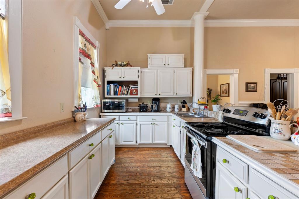 404 East Main Street Ladonia, TX 75449 - Photo 8 of 27 a kitchen with a sink stove and cabinets