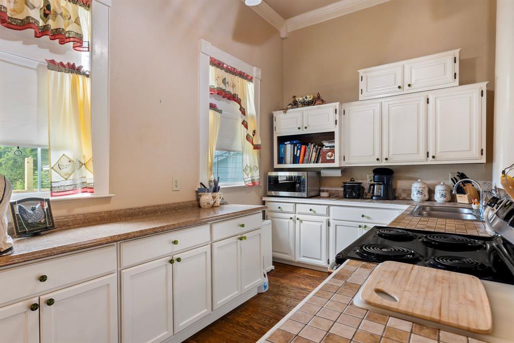 404 East Main Street Ladonia, TX 75449 - Photo 9 of 27 a kitchen with white cabinets and appliances