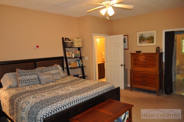 751 Pine Hill Road Boone, NC 28607 - Photo 7 of 27 a bedroom with a bed and a chandelier