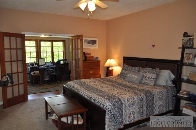 751 Pine Hill Road Boone, NC 28607 - Photo 8 of 27 a bedroom with a bed and wooden floor