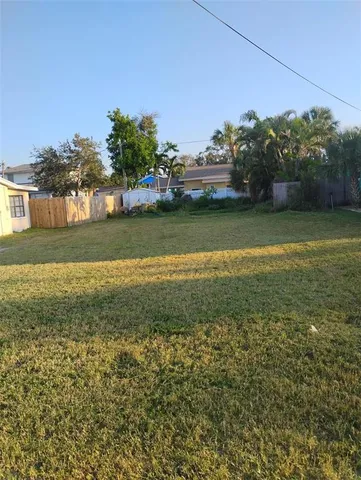 a view of a yard with a house in the background