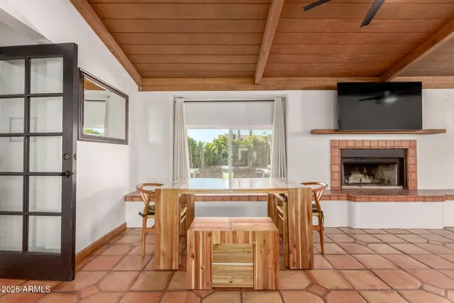 a dining room with furniture and a fireplace