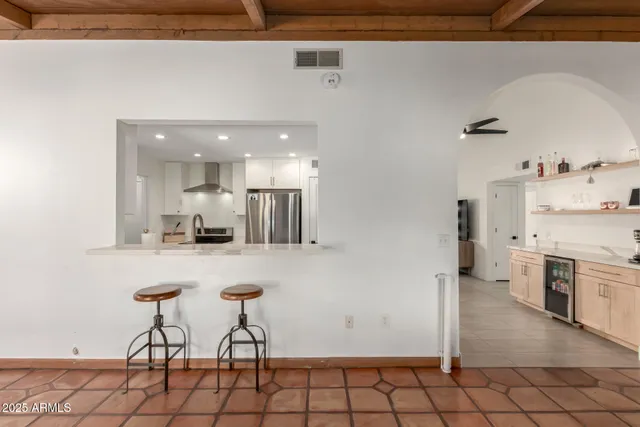 a kitchen with stainless steel appliances a refrigerator and a stove top oven
