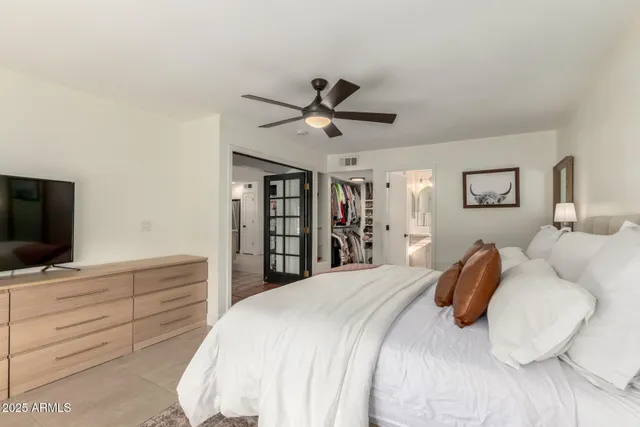 a bedroom with a bed and a flat screen tv