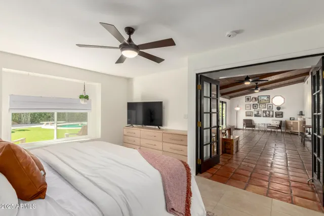 a bedroom with a bed and a view of living room