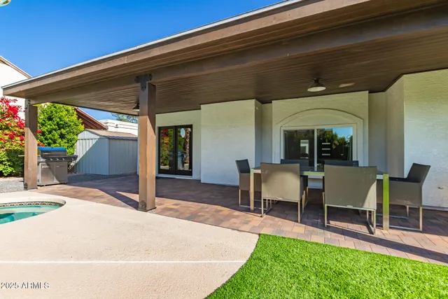 a view of a patio with table and chairs and potted plants