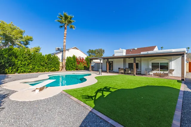 a front view of house with outdoor seating and yard