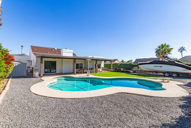 a view of pool with umbrella and yard