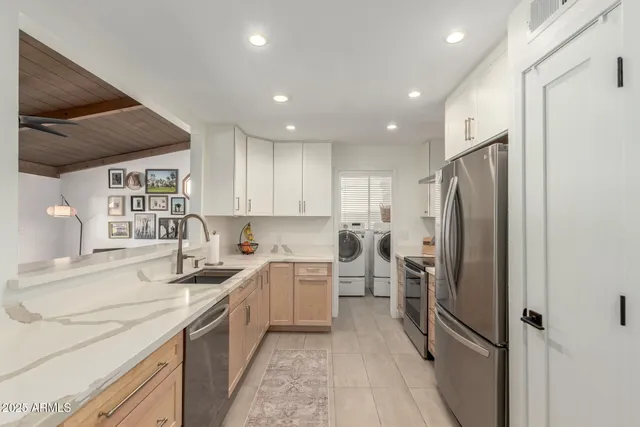 a kitchen with a sink stainless steel appliances and cabinets