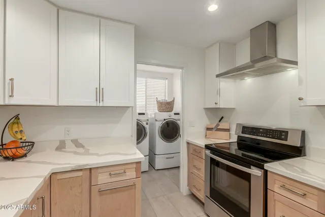 a kitchen with a stove and a white cabinets