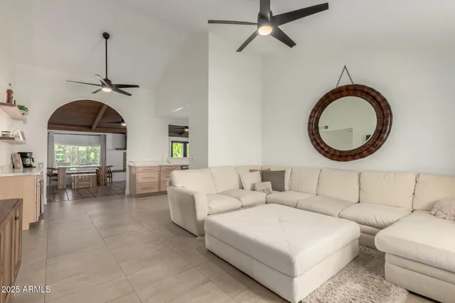 a living room with furniture a window and a chandelier