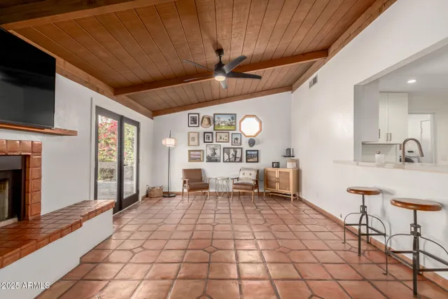 a living room with a large window and furniture