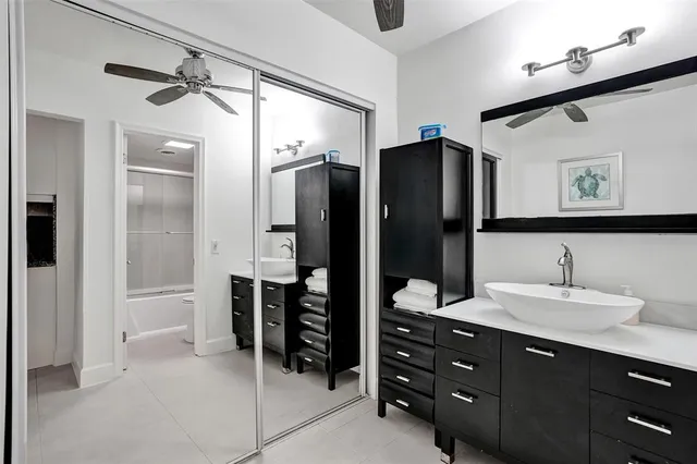 a bathroom with a sink vanity toilet and shower