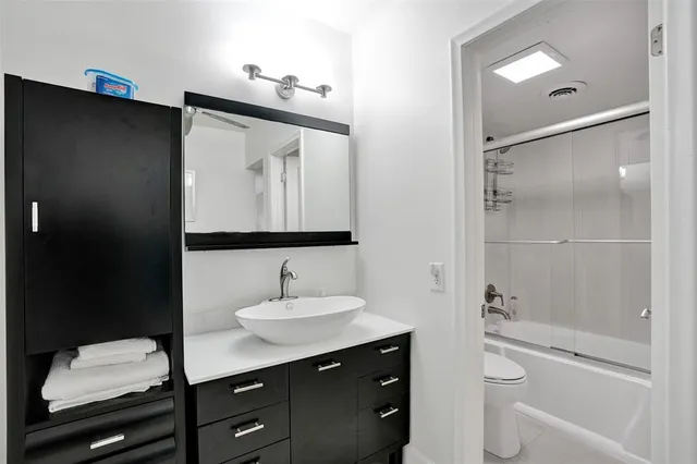 a bathroom with a shower and a sink