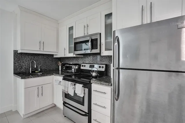 a kitchen with a sink cabinets and stainless steel appliances