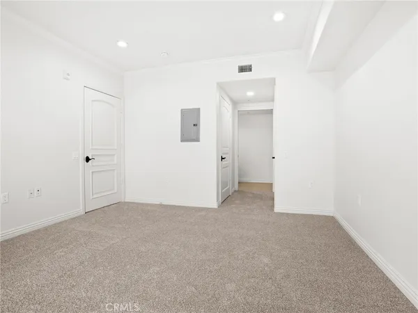 an empty room with closet and a bathroom