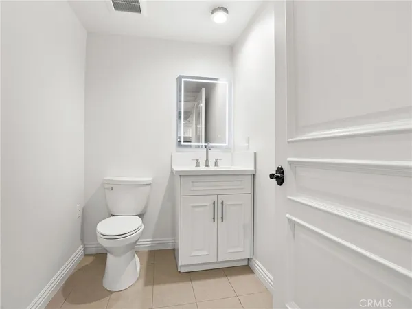 a bathroom with a toilet sink and a mirror