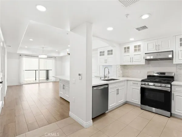 a kitchen with stainless steel appliances granite countertop a stove and a refrigerator