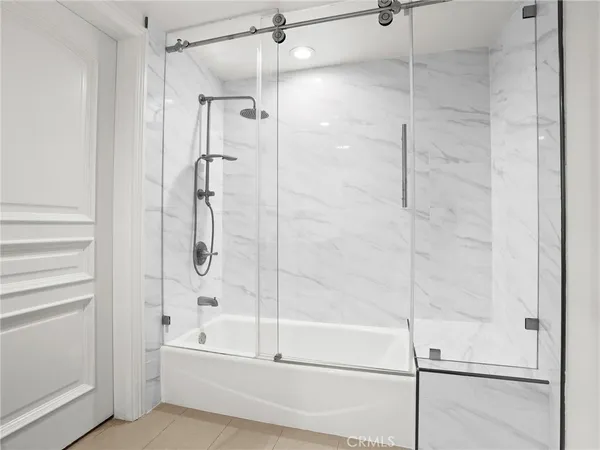 a bathroom with a bathtub and a shower