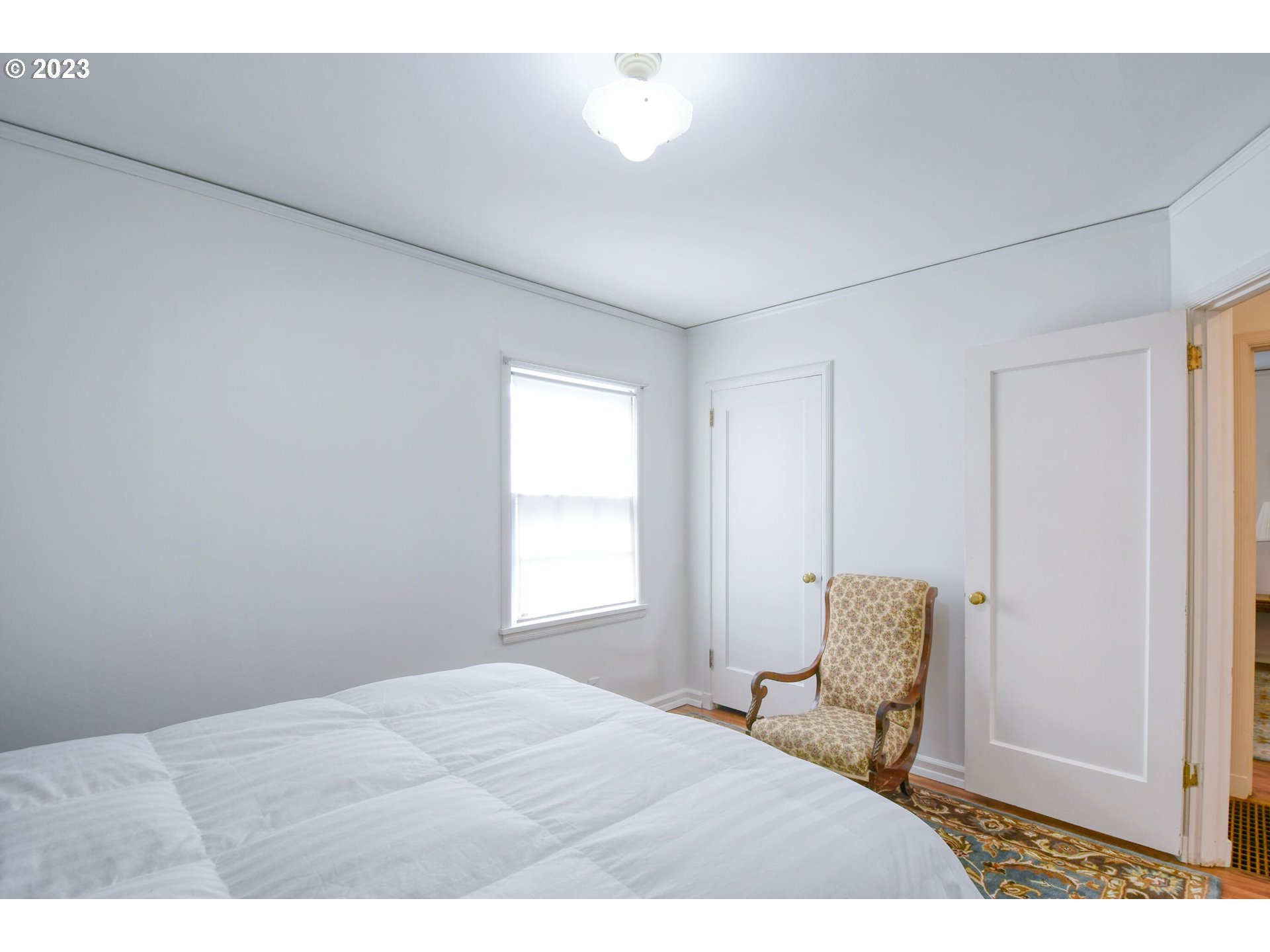 630 Northwest 9th Street Pendleton, OR 97801 - Photo 17 of 45 a bedroom with a bed a chair and next to a window