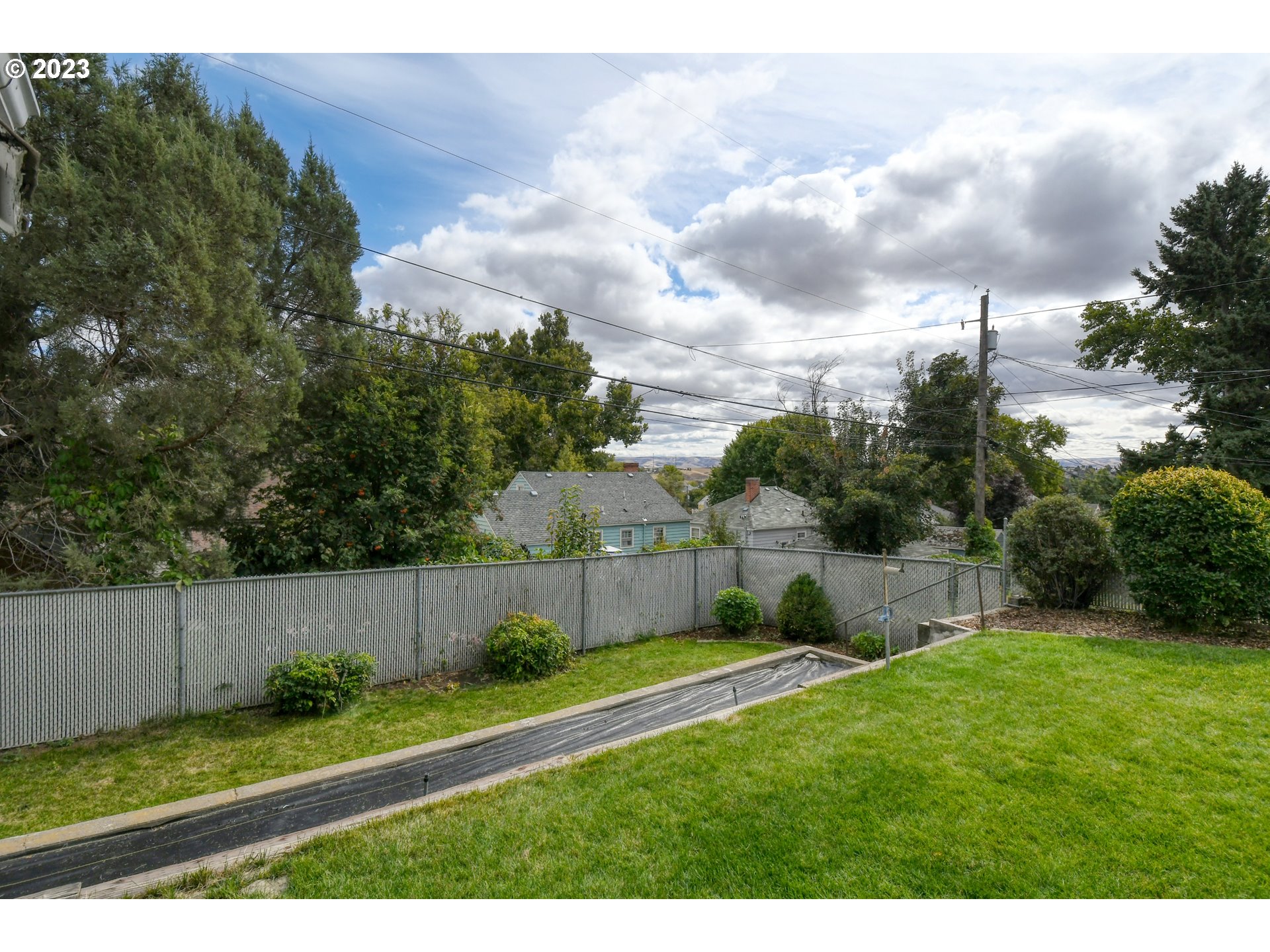 630 Northwest 9th Street Pendleton, OR 97801 - Photo 41 of 45 a view of a backyard with grass and a fence