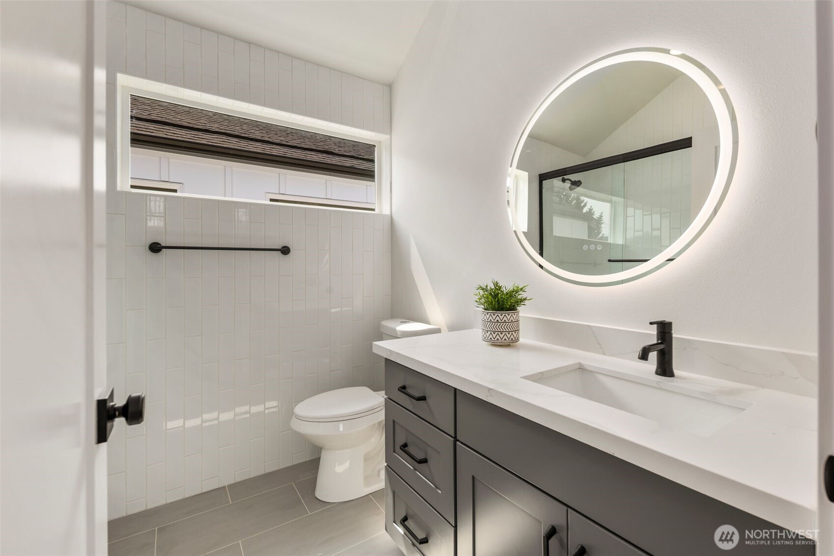 820 South Sullivan Street Seattle, WA 98108 - Photo 13 of 18 a bathroom with a sink a toilet and a mirror