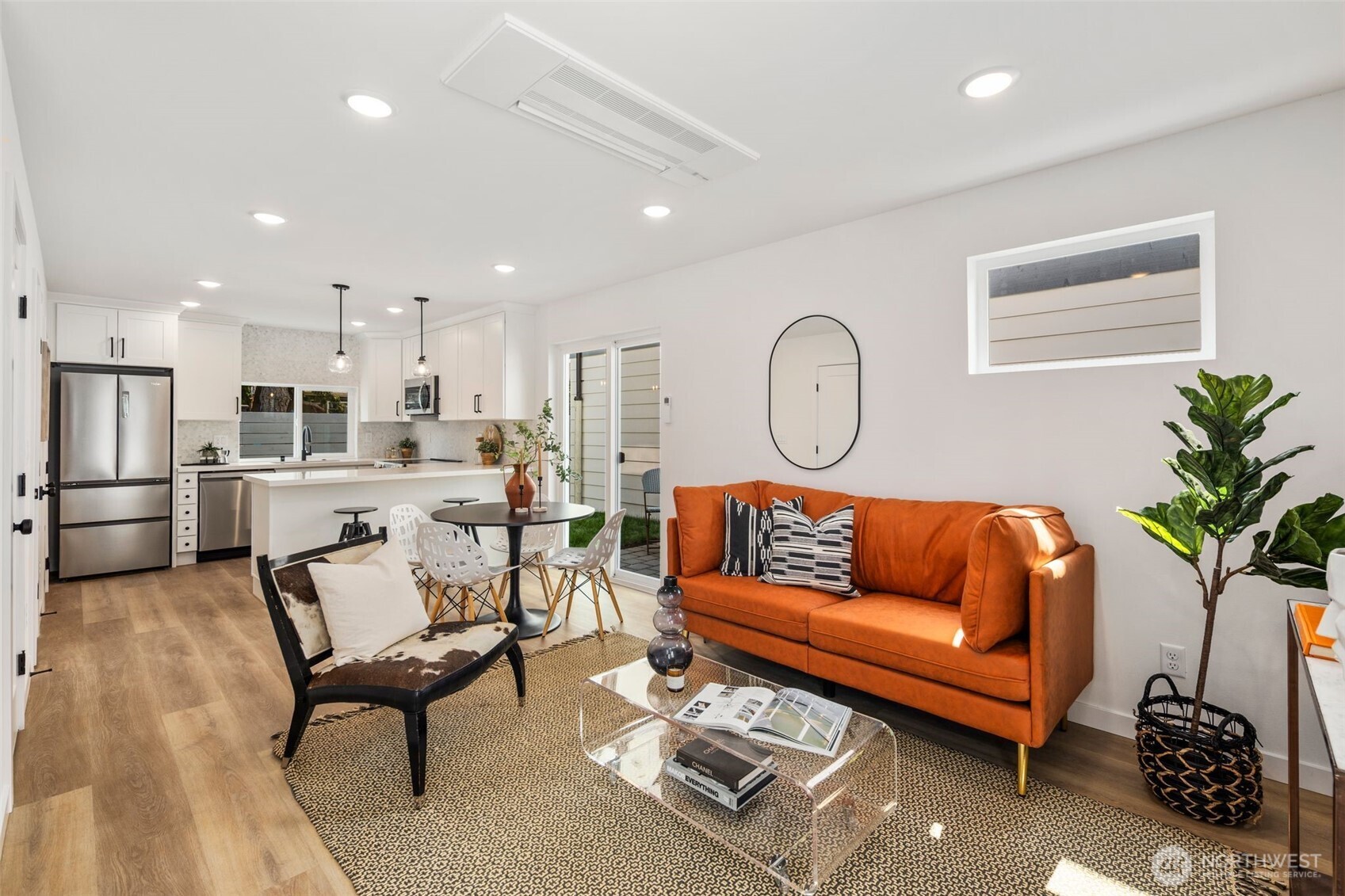 820 South Sullivan Street Seattle, WA 98108 - Photo 4 of 18 a living room with furniture a rug kitchen view and a potted plant