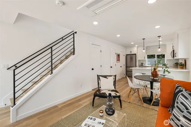 a living room with furniture a window and wooden floor