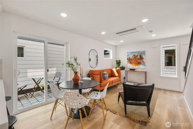 a kitchen with stainless steel appliances a stove a sink a refrigerator a center island and chairs