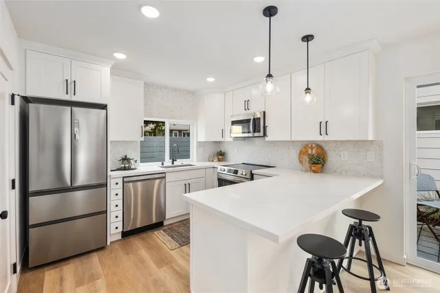 a kitchen with stainless steel appliances granite countertop a sink stove microwave and cabinets