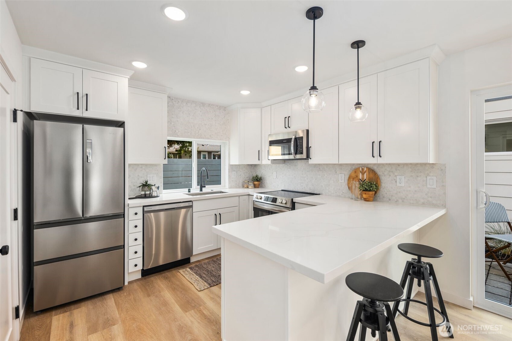 820 South Sullivan Street Seattle, WA 98108 - Photo 7 of 18 a kitchen with stainless steel appliances a stove a sink a refrigerator a center island and chairs