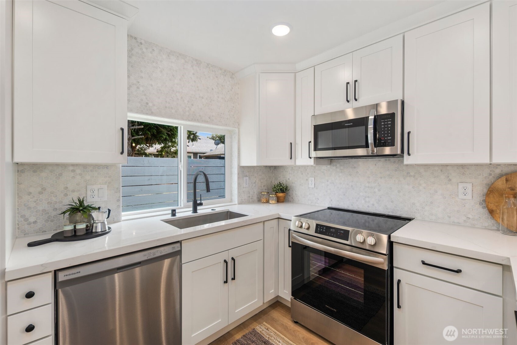 820 South Sullivan Street Seattle, WA 98108 - Photo 8 of 18 a kitchen with stainless steel appliances granite countertop a sink stove microwave and cabinets