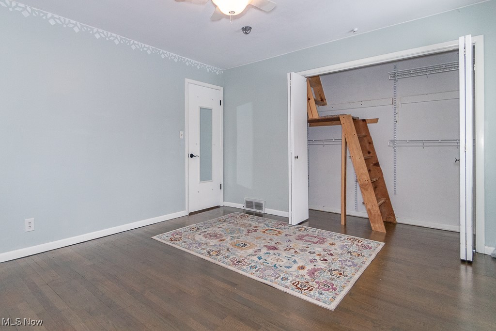 38856 Johnnycake Ridge Road Willoughby, OH 44094 - Photo 16 of 49 Bedroom featuring ceiling fan, dark hardwood flooring, and a closet with access to the loft reading room