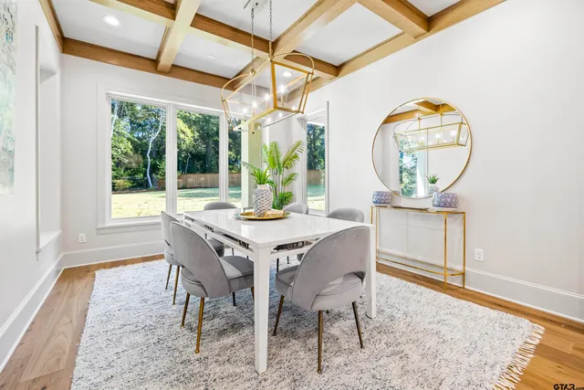 a dining room with furniture a rug and a large window