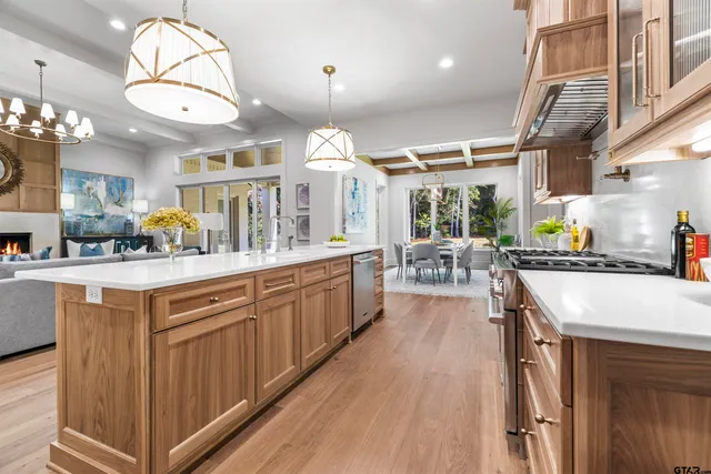 a kitchen with stainless steel appliances granite countertop a stove and cabinets