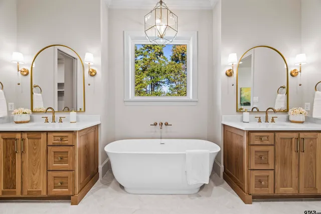 a spacious bathroom with a sink and a mirror