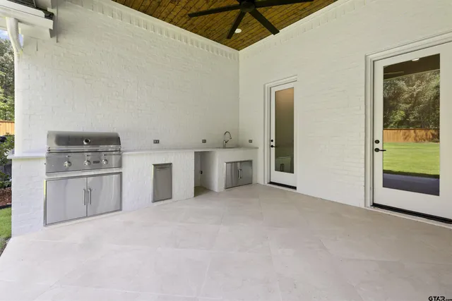 a view of a kitchen with refrigerator and white cabinets