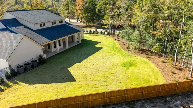 a swimming pool with some trees in the background