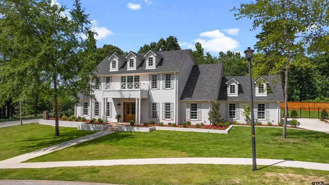 a front view of house with yard and green space