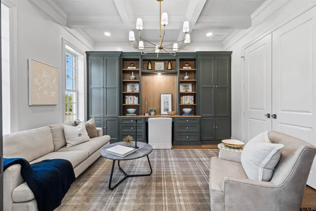 a living room with furniture a chandelier and a dining room view