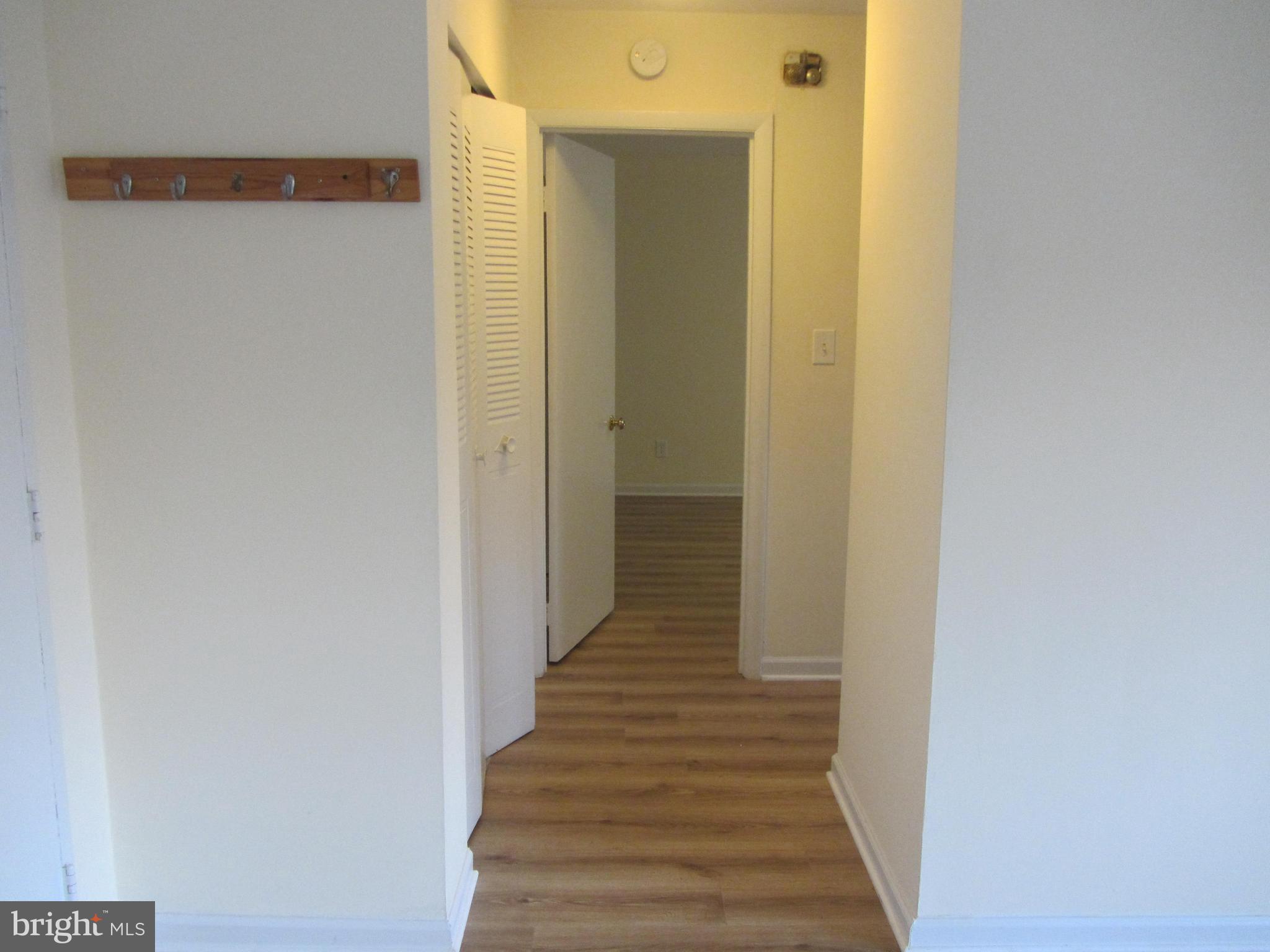614 Sligo Avenue, Unit 303 Silver Spring, MD 20910 - Photo 15 of 31 a view of a hallway with wooden floor
