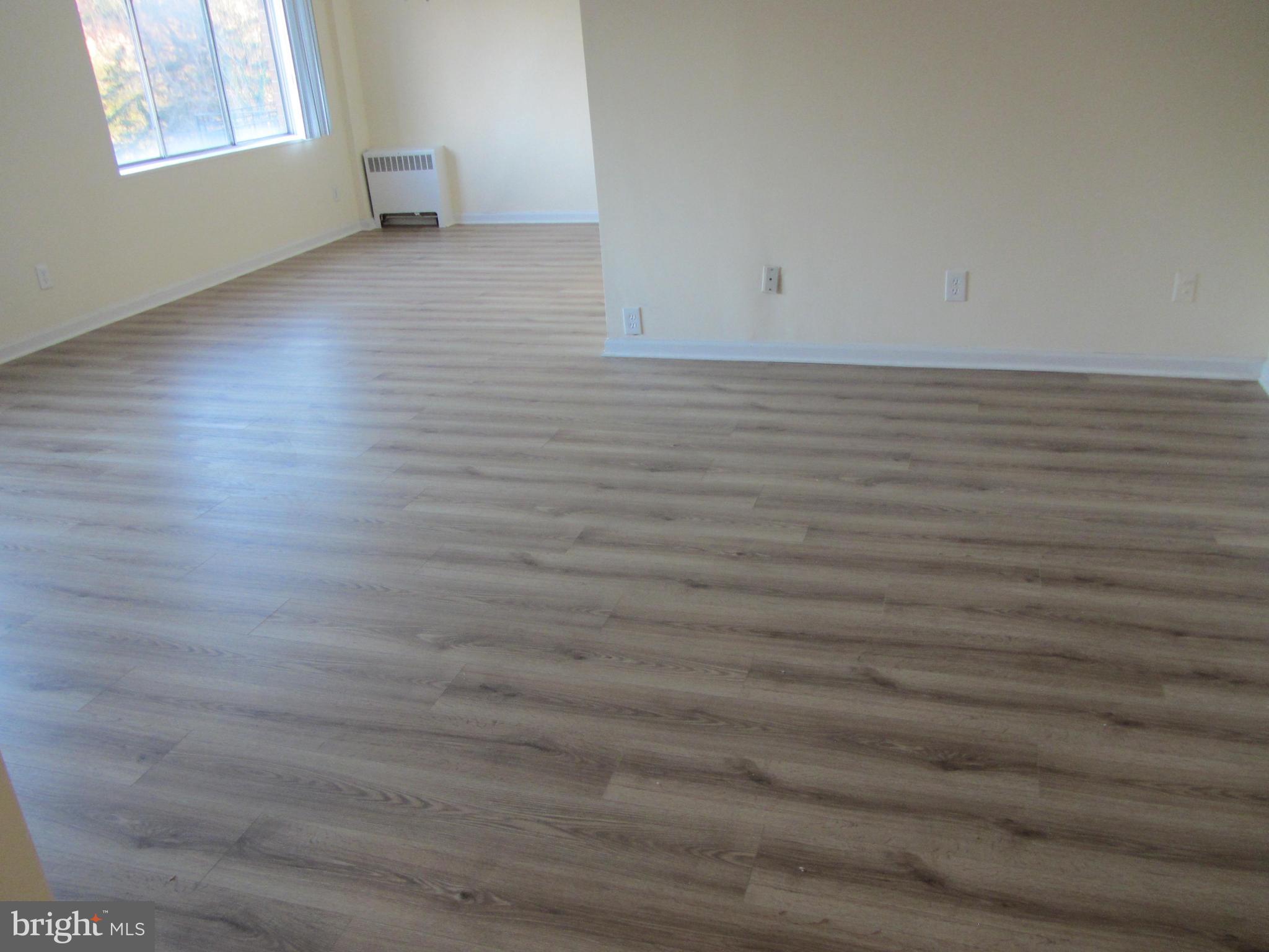 614 Sligo Avenue, Unit 303 Silver Spring, MD 20910 - Photo 17 of 31 a view of a room with wooden floor and window